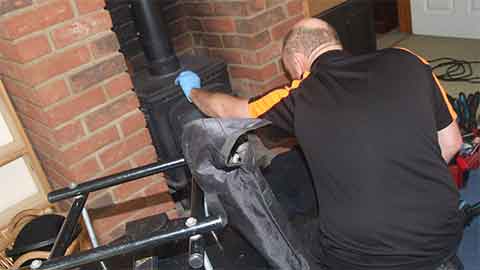 Scott Regan inspecting debris removed from a chimney after sweeping