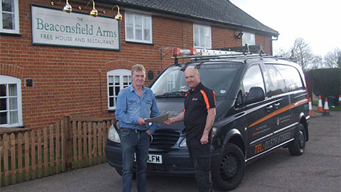 Scott Regan handing certificate of completion to customer in Occold, Suffolk after chimney sweep
